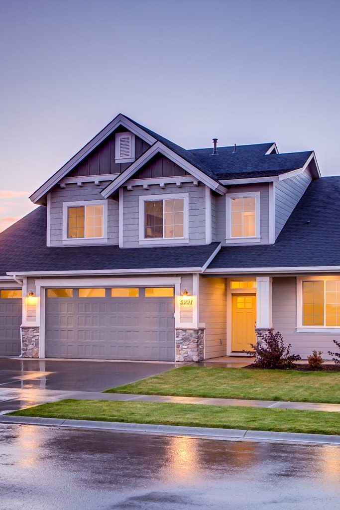 Elegant suburban home with driveway at sunset showcasing modern architecture.